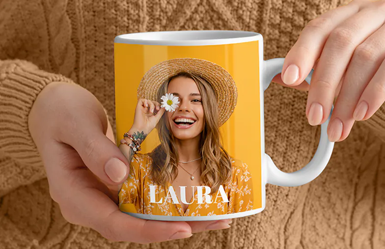 ["Personalised photo mugs from Printerpix", "Mum and baby holding a Printerpix cartoon design mug with 'Dad' text", "Personalised photo mug with image of a crawling baby in animal onesie", "Mum and daughter holding custom photo mugs with family pictures", "Kissing couple with personalised mugs with text", "Personalised photo mug with own dog photo", "", "", "", "", ""]||||||||||