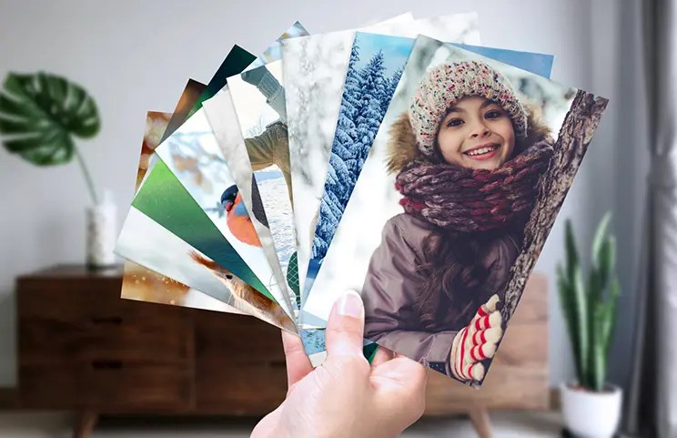 Photo prints from Printerpix|Stack of individually designed photo prints from the Printerpix online photo service|Small, medium, and large photo prints on a table, created with a mobile phone|Photo prints|Hands holding a photo print of three children on holiday|Various sizes of online photo prints from family photos taken with a mobile phone|||||