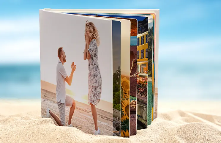 Hardcover Personalised Photo Books from Printerpix|Custom Printed Printerpix Photo Album with Hardcover and Large Photos of an Elderly Couple|Personalised Photo Album with Romantic Pictures of a Couple and Photo Cover|Family Photo Album with Custom Printed Cover and Family Name|Pet and Woman Looking at Personalised Family Photo Book with Custom Design|Two People Looking at a Printerpix Photo Book with Wedding Photos and Bride|||||