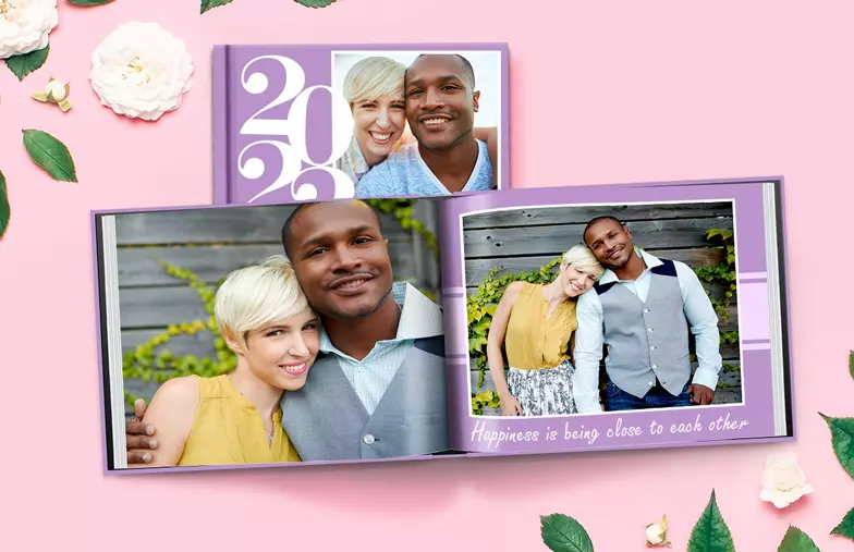 Hardcover Personalized Photo Album by Printerpix|Custom-printed Printerpix photo album with hardcover and large photos of an older couple|Personalized photo album with romantic pictures of a couple and photo cover|Family photo album with custom-designed cover and family name|Pet and woman looking at personalized family photo album with custom design|Two people viewing a Printerpix photo book with wedding photos and bride|||||