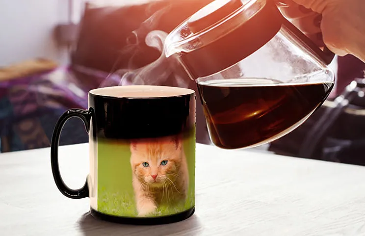 Young boy holding a customised magic mug with his own photo on it