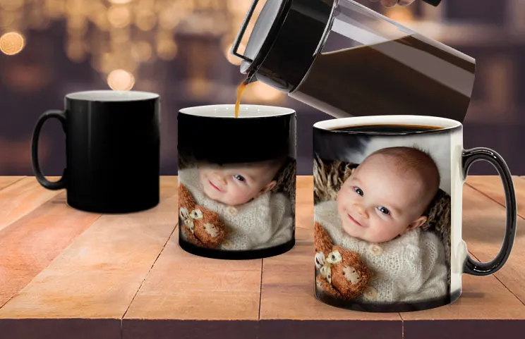 Young boy holding a custom-designed colour-changing mug with a photo of himself