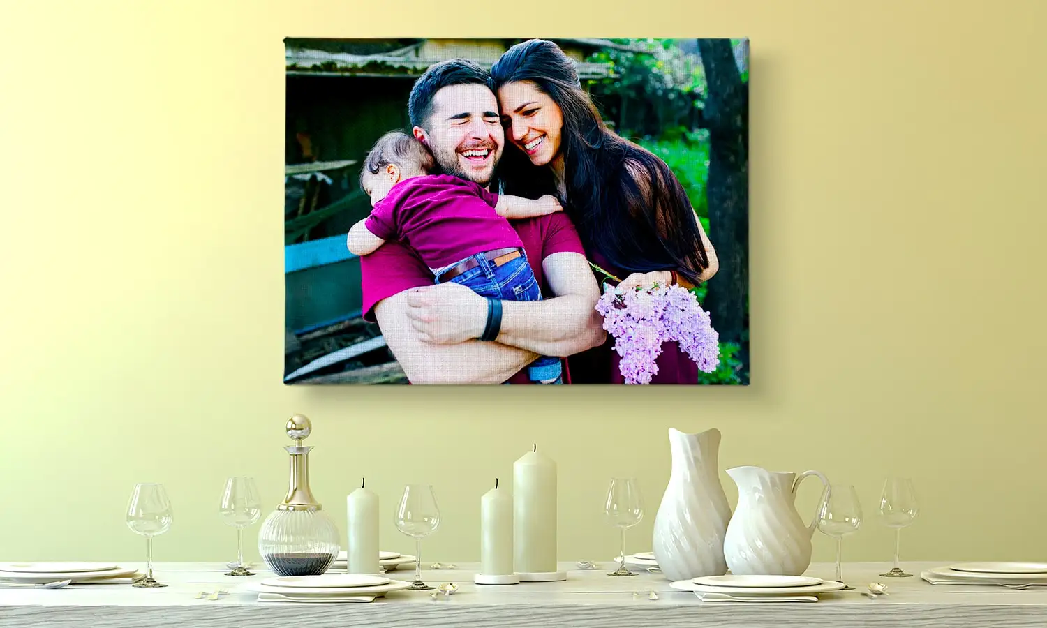 A young woman bends down to pet a golden Labrador lying on yellow grass