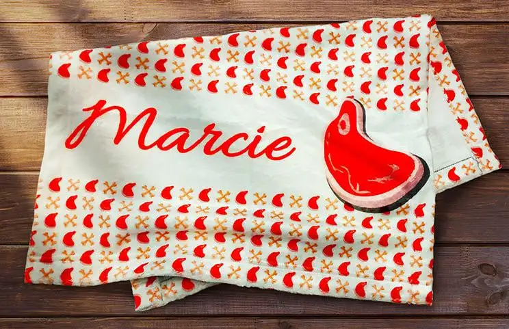 Folded personalised dog blanket with dog's name and image of dog food