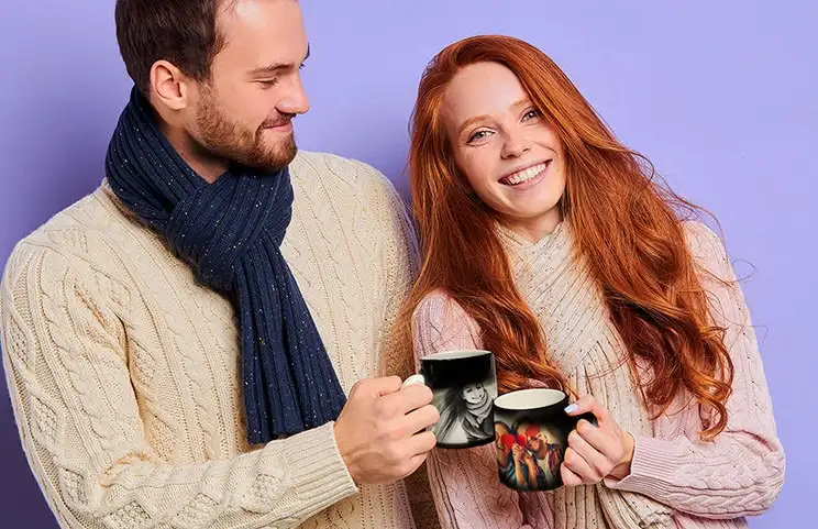 Magic mug with a picture of a cat, being filled with tea on a desk