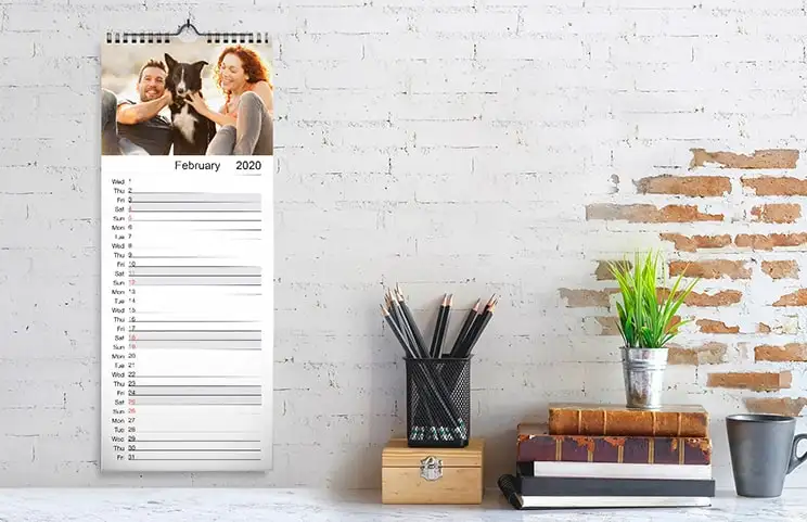 Woman Looking at Customised Calendar with Photo of a Dog Taken with a Mobile Phone