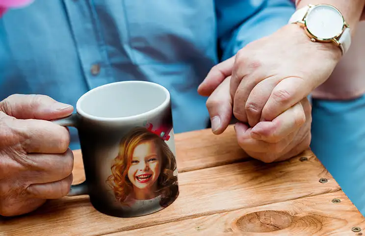 Personalised magic mug with a revealed photo of a young woman